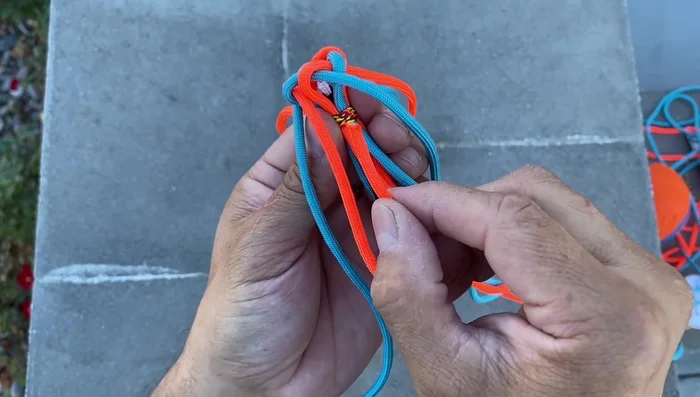 Form the Turks Head Knot: Bring each cord through the center of the hexagon, creating a star-like pattern. Tighten securely.