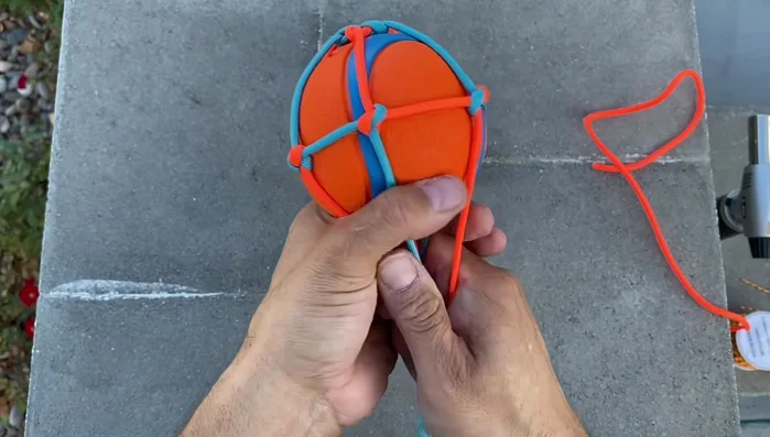 Secure the bottom: Create another collar at the bottom of the ball using the same method as the top, ensuring color alternation.