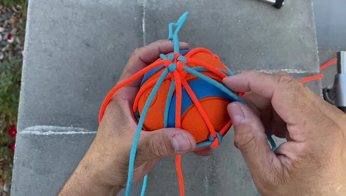 Create the Matthew Walker Knot: Using each cord individually, make overhand knots around the bottom collar, threading each knot under the previous loops to secure the Matthew Walker knot. Repeat this process until all strands are used.