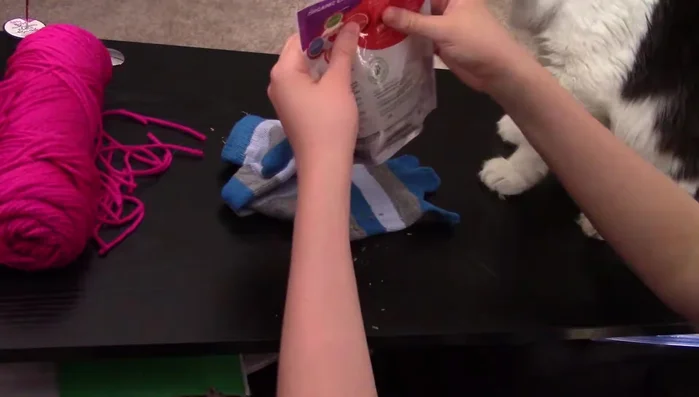 Fill the sock with catnip. Use a smaller container if needed for easier pouring.