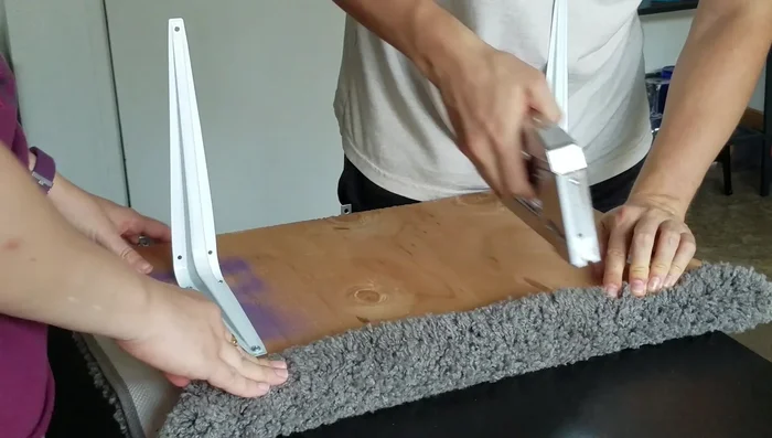 Attach a bath mat to the platform using a staple gun.