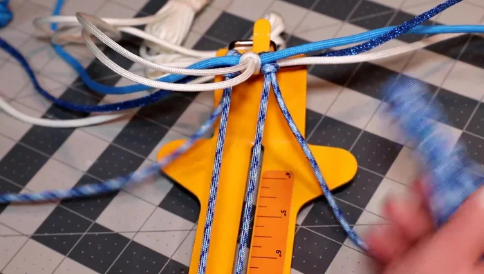 Weave the colonial blue cord over the two horizontal pieces, up the middle, alternating sides.