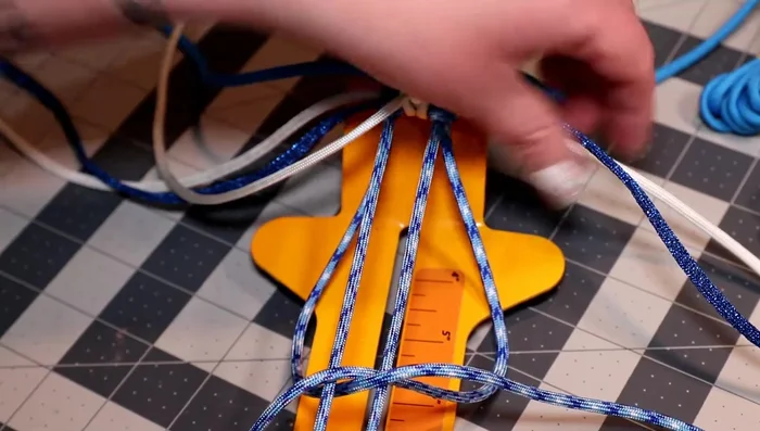 Weave the colonial blue cord over the two horizontal pieces, up the middle, alternating sides.