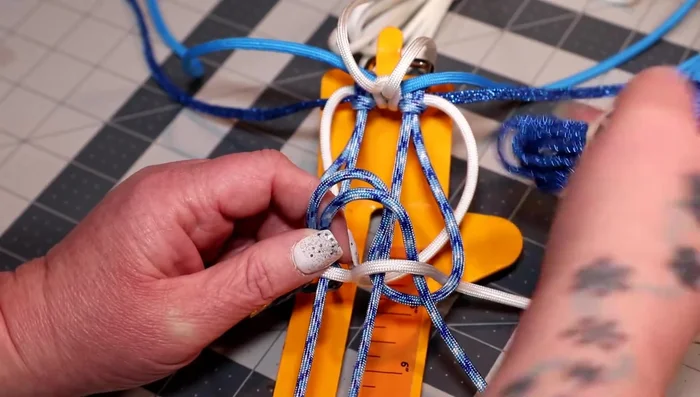 Weave the colonial blue cord over the two horizontal pieces, up the middle, alternating sides.