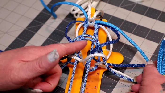 Weave the colonial blue cord over the two horizontal pieces, up the middle, alternating sides.