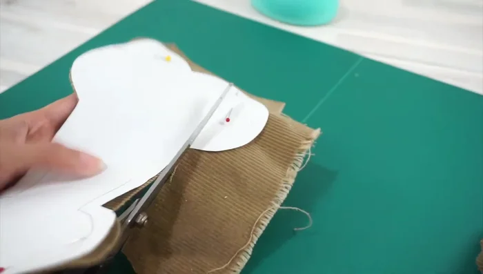 Stuff the ends with fabric scraps, add crinkle material, and sew the opening shut using a ladder stitch.