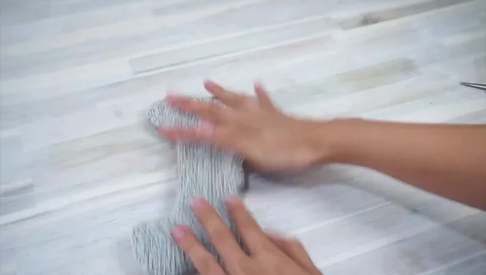 Stuff the ends with fabric scraps, add crinkle material, and sew the opening shut using a ladder stitch.