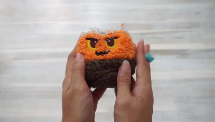 Tie a knot to secure the toy.