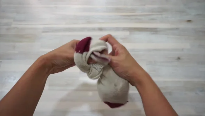 Tie a knot to secure the toy.