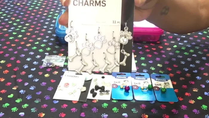 Gather your supplies: charms, lobster clasps, jump rings, and optional embellishments like beads or bells.