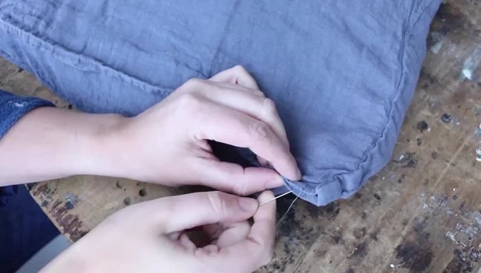 Close the opening of the pillowcase with a needle and thread using a matching thread. Hand-stitch the opening closed.