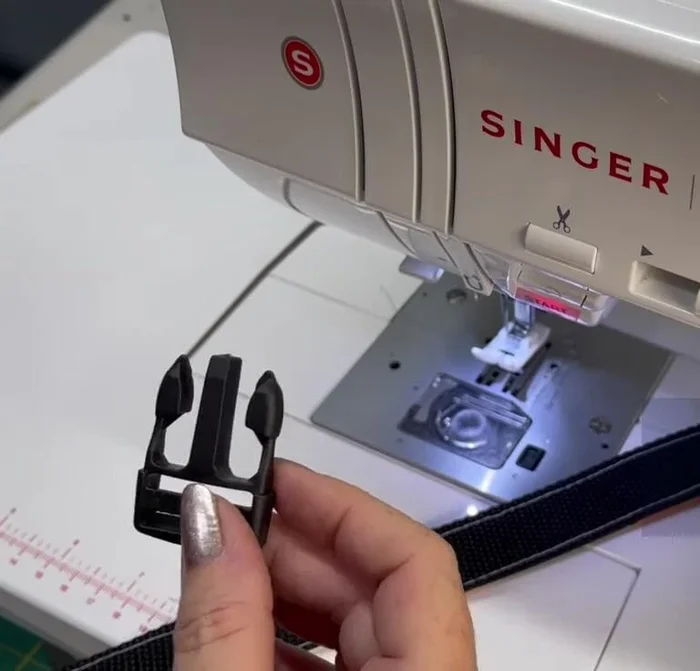 Attach clip and D-ring: Thread the other end of the webbing through the parachute clip, secure with strap slider. Add D-ring, fold and sew the edges of the fabric and webbing.