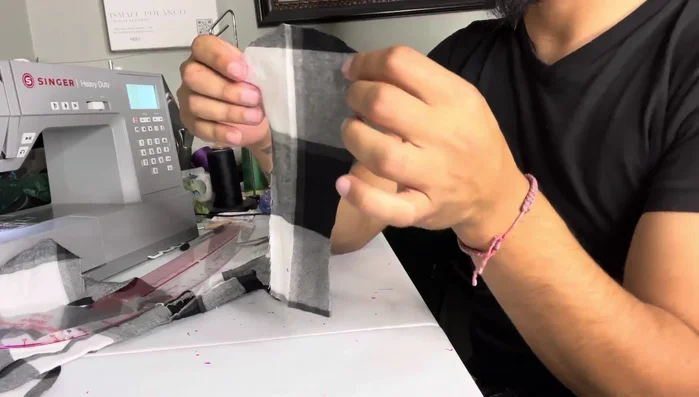 Attach sleeves and leg holes: Attach the sleeve pieces and the leg openings.