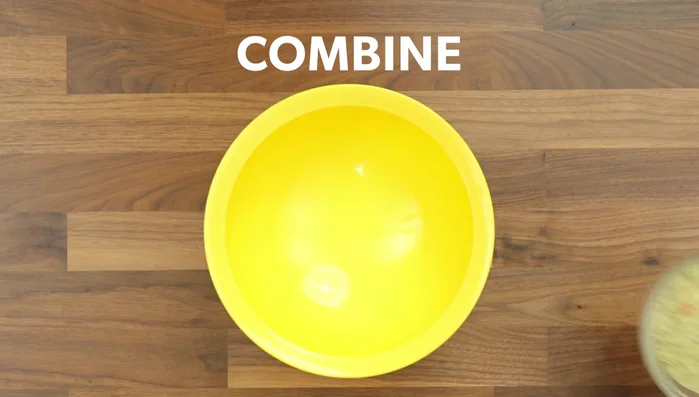 Combine dehydrated dog food, rice flour, fruit apples, chicken broth, and ¾ of a tube of peanut butter in a large bowl.