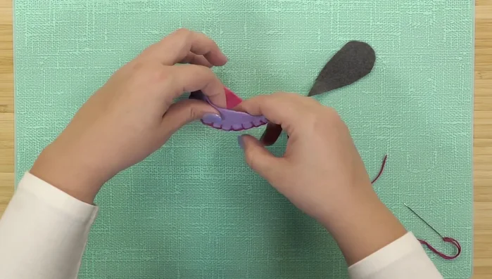 Sew the bottom piece to the side pieces using a blanket stitch, leaving a one-inch opening.