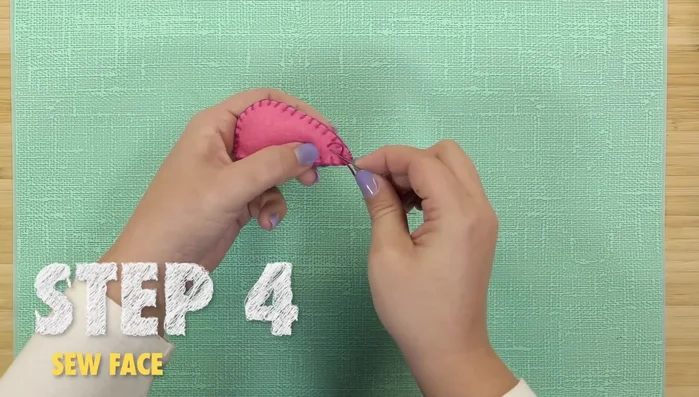 Sew the elastic tail to the back of the mouse.