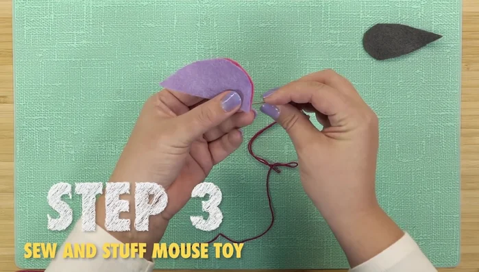 Sew the bottom piece to the side pieces using a blanket stitch, leaving a one-inch opening.