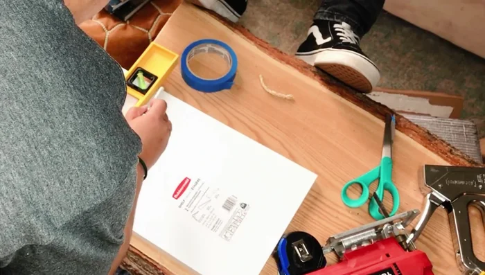 Cut and staple green grass carpet onto shelves.