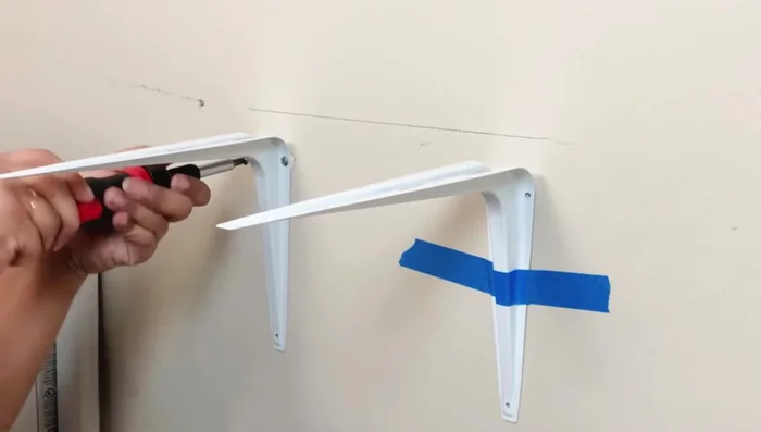Attach shelves to brackets using screws.