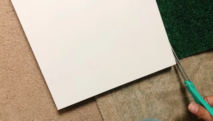 Cut and staple green grass carpet onto shelves.