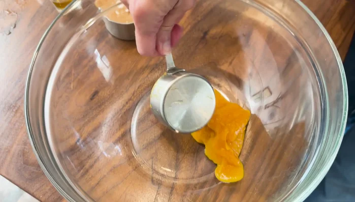 Mix wet ingredients: 1/3 cup pumpkin puree, 1/2 cup all-natural peanut butter, 1 beaten egg, 1 tbsp honey.