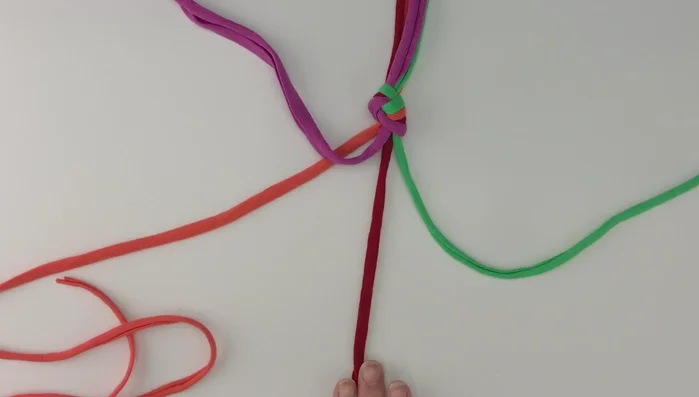 Tighten the knot by pulling all four strings simultaneously. This is the first knot of your rope.