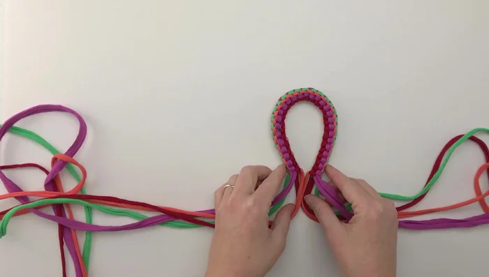 Once the loop is created, fold it in half and pair up the colors on either side.