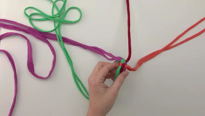Continue knotting until you reach the desired length for the toy's body (around 6.25 inches).
