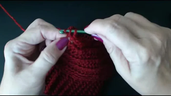 Continue working double crochets along the top edge, securing the ear hole openings.