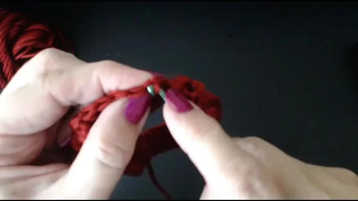 Join the row by slipping the hook through the top of the beginning chain-3, pulling through.