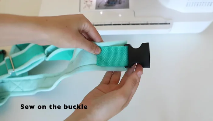 Sew on the plastic buckle for the back strap.