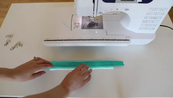 Create 15-inch pull straps: place webbing on fleece, sew perimeter, attach trigger snaps.