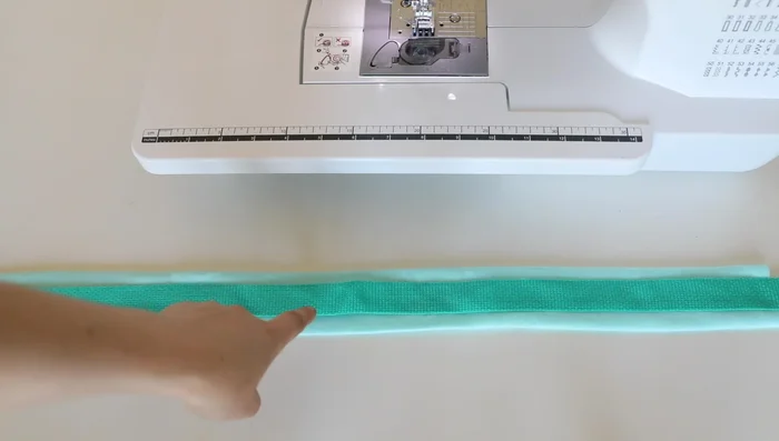 Create a 12-inch semi-rigid handle: fold and sew fleece and webbing; insert plastic tubing or corset boning.