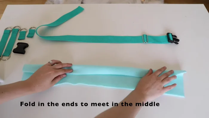 Place webbing on fleece, sew down center and sides for stability.