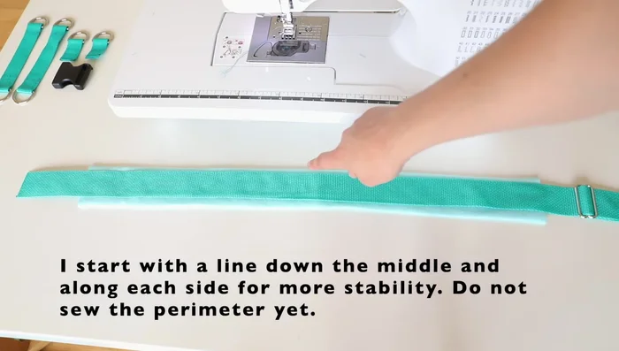 Place webbing on fleece, sew down center and sides for stability.