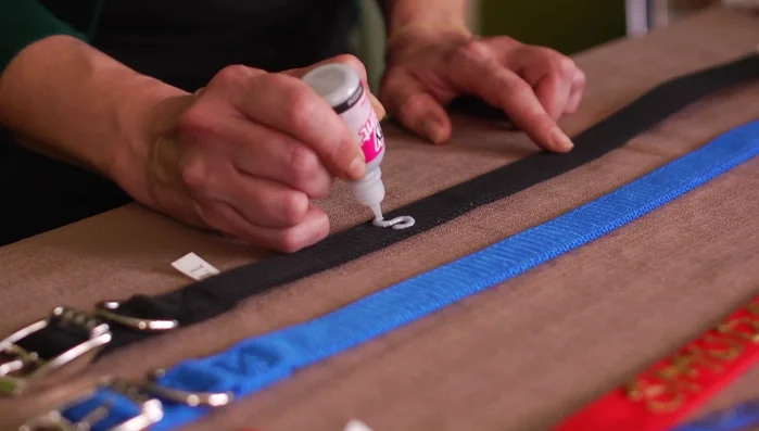 Write your pet's name using puffy paint. Apply gentle pressure and hold the paint slightly slanted to avoid air bubbles.