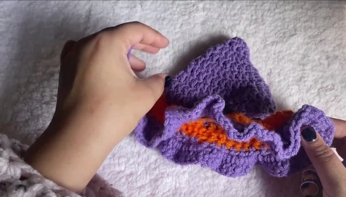 Create ear flaps: Find the 6th chain from the center back. Chain 35. Single crochet across chain, slip stitch to first chain. Repeat for other ear.