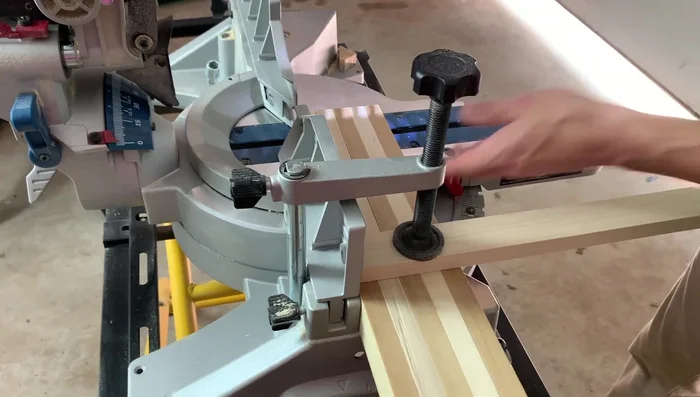 Add the slats to the bottom of the dog bed. Space them evenly and glue and nail them in place.