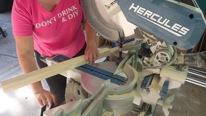 Cut the wood for the dog bed frame using a miter saw. This includes four sides, two long rails, several slats for the middle, and four legs.