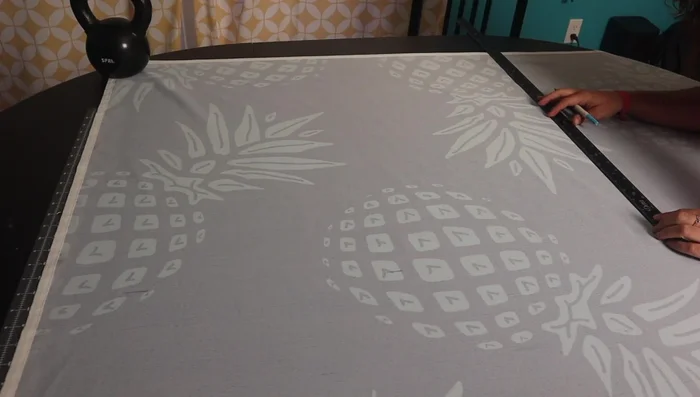 Cut and sew the fabric for the tent cover, ensuring to hem the edges to prevent fraying.