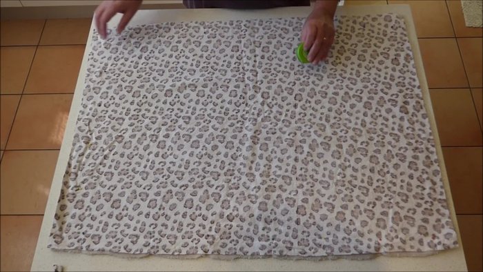 Prepare the main fabric pieces: Cut two rectangular pieces of fabric. The larger measurement is approximately 85 centimeters (33.5 inches), and the shorter side is 66 centimeters (26 inches).