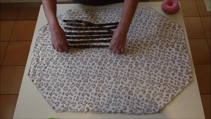 Attach the ribbons: Place the ribbons along the edges of the fabric, with the longer end of each ribbon tucked inside the fabric. Pin the ribbons in place, ensuring that the short ends are tucked in at the corners.