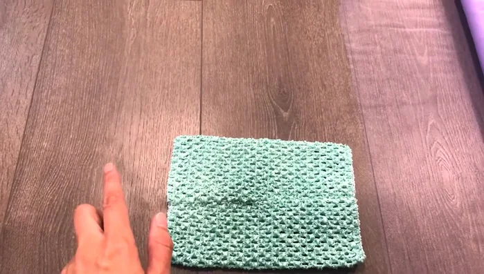 Prepare tulle strips. Fold over the folded end to remove excess fabric. Cut approximately 4 inches to achieve desired width.