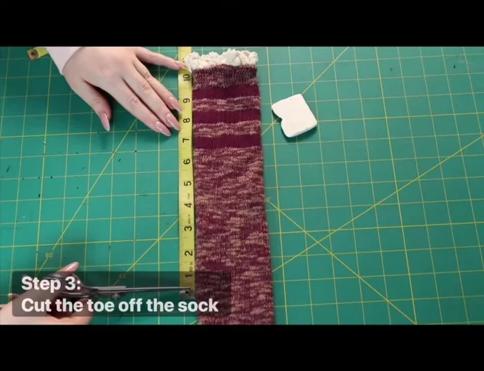Cut the toe off the sock. If using a longer sock, cut the toe end shorter to the length of the kitten's measurement, forming a tube open on both ends.