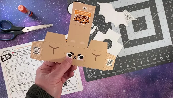 Make mountain folds along all dotted lines using a ruler and the round edge of a paperclip to create score lines.