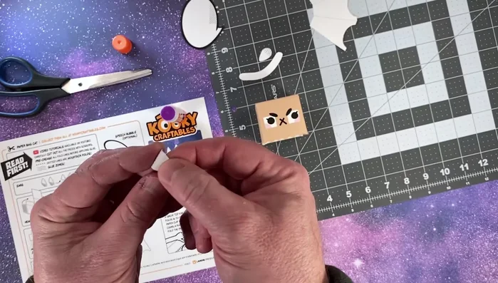 Fold and glue the ears onto the head.