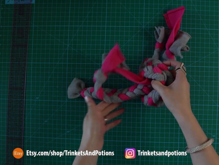 Combine the ropes: Tie the two braided ropes together with a large, secure overhand knot (pull tight to reduce size).