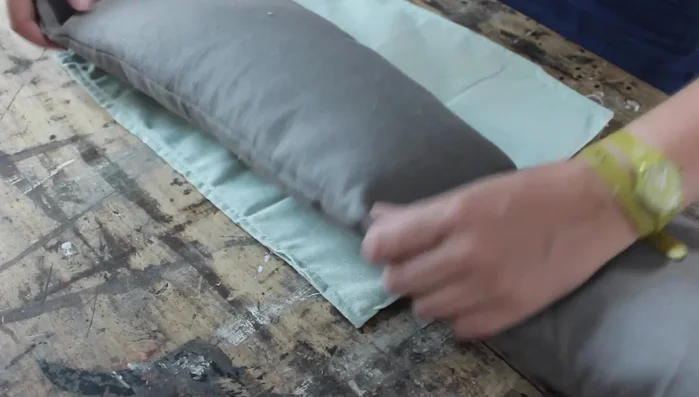 Attach the side piece to the base, aligning the edges and corners carefully. Stitch along the bottom edge, completing the basket.