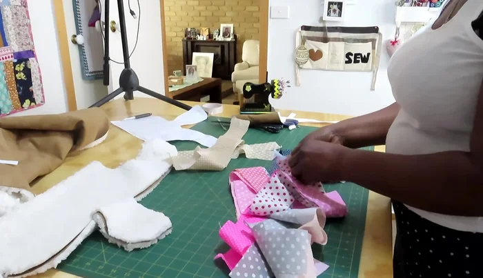 Create and attach binding to the edges of the coat.