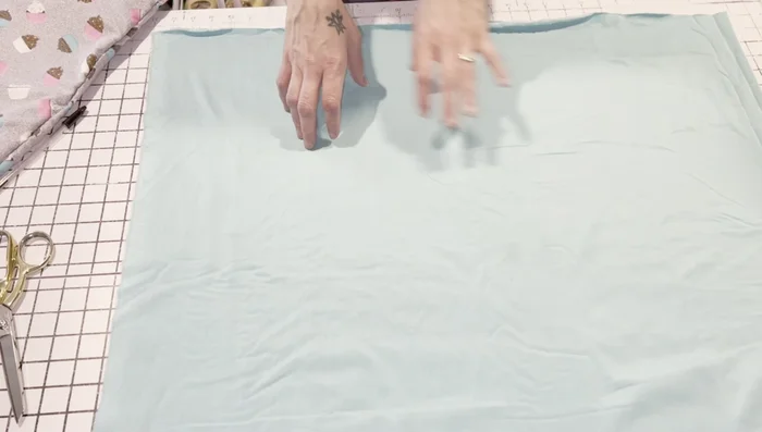 Cut minky/fleece to a size 3 inches longer than the flannel piece (example: 16x27 inches). Stitch three sides, leaving the top open.